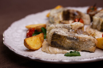 fish dishes. pieces of fish with potatoes on a plate