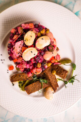 top view salad vinaigrette with black bread on a plate