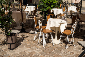 tables with a tablecloth and chairs on a summer terrace in a cafe