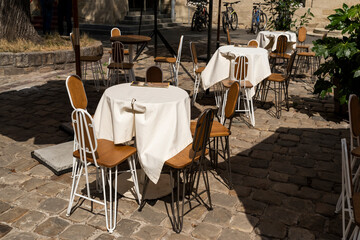 tables with a tablecloth and chairs on a summer terrace in a cafe