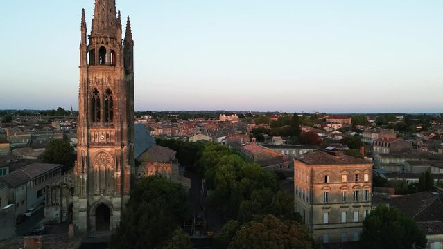 Aerial video of Libourne, France during golden light in Bordeaux with church spire