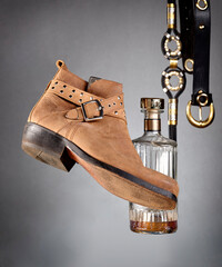 A flying shoe, a bottle of whiskey and a whip