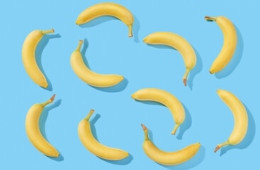 Yellow bananas on blue pastel background