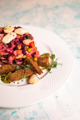 salad vinaigrette with black bread on a plate