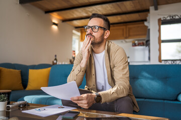 Man mature caucasian male work at home hold contract document