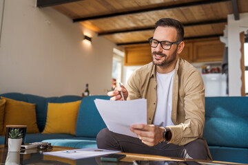 Man mature caucasian male work at home hold contract document