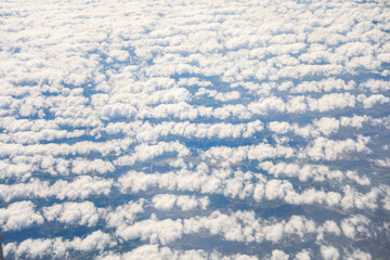 An airplane view of clouds symbolizes freedom, imagination, and perspective. The vast expanse of the sky inspires awe and wonder, offering a sense of detachment from the daily grind 