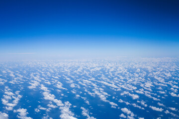An airplane view of clouds symbolizes freedom, imagination, and perspective. The vast expanse of...