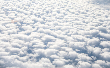An airplane view of clouds symbolizes freedom, imagination, and perspective. The vast expanse of...