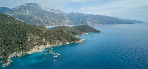 Fototapeta na wymiar A stunning aerial view of Oludeniz surroundings in Turkey, with sparkling blue sea and tranquil landscape; a peaceful reminder of nature's beauty.