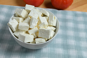 bowl of feta cheese cubes on table closeup