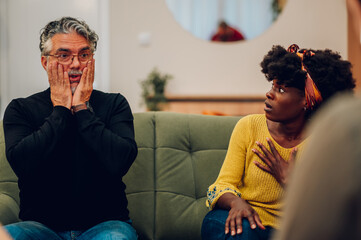 Senior man talking about his mental health on a group therapy session