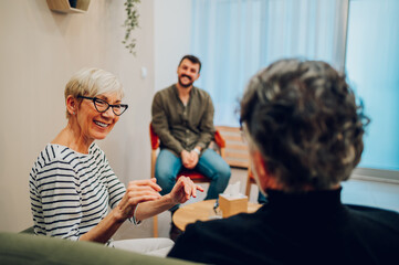 Senior people talking about their mental health on a group therapy session