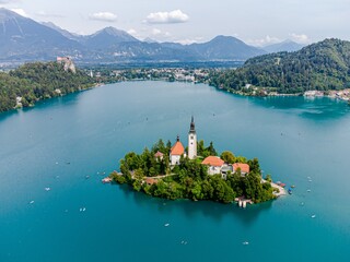Beautiful idyllic aerial view on island, castle, catholic Maria church in lake Bled.  Slovenia
