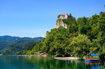 Fototapeta na wymiar Beautiful idyllic view on island, castle, catholic Maria church in lake Bled. Slovenia