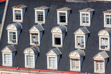 Argentina, Buenos Aires. Many dormer windows in a sloping roof.