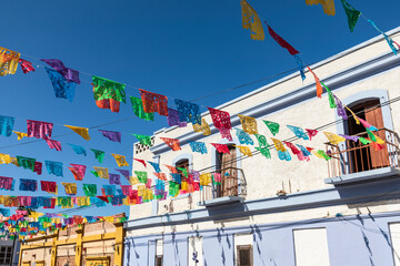 Todos Santos, Baja California Sur, Mexico. Festive colorful banners over a street. - obrazy, fototapety, plakaty