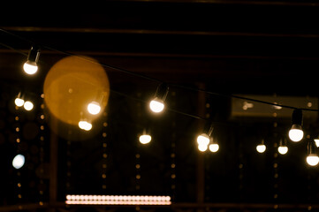 The cafe is decorated with a garland of lamps, beautiful atmospheric light