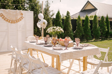 rustic outdoor birthday decor, table setting and photo zone