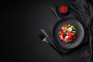 Delicious, fresh Greek salad with feta cheese, olives, tomatoes and cucumbers