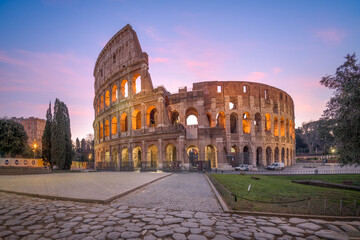 Rome, Italy at the ancient Roman Colosseum Amphitheater at night. - obrazy, fototapety, plakaty