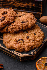 Delicious baked oatmeal raisin cookies on a dark concrete background