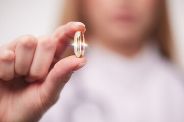 doctor holding a transparent pill in his hands close-up