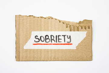 SOBRIETY word written in marker on sticky tape and cardboard. SOBRIETY concept.