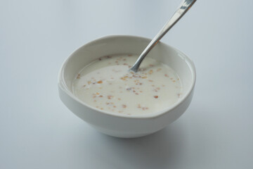 oats, banana and milk in a bowl on black background 