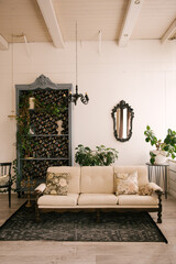 Classic interior, with wooden sofa, vintage sideboard, mirror and flowers