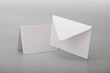 White empty envelope levitating on gray background with shadow postcard. Mockup.