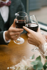 glasses of wine in hands of a couple in love