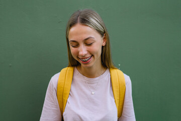 Closeup front view of a cue teenage girl with braces