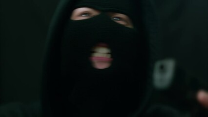 Caucasian Criminal Shouts and Points Gun Past Camera. Shot with ARRI Alexa in ARRIRAW and exported QuickTime Apple ProRes 422 HQ.