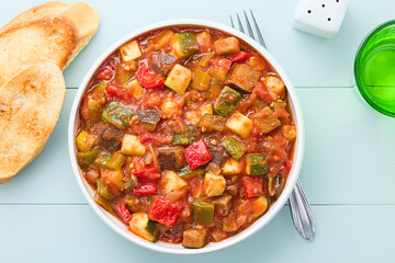 Fresh Ratatouille, a traditional French vegan vegetable stew made of eggplant, zucchini, bell...