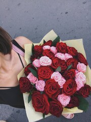 A girl with a large bouquet of roses
