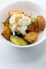 salad with potatoes and cheese on a white background
