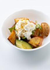 salad with potatoes and cheese on a white background