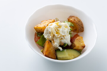 salad with potatoes and cheese on a white background