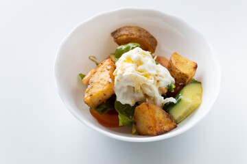 salad with potatoes and cheese on a white background