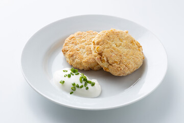 fish cutlet with sour cream on a white background