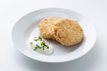 fish cutlet with sour cream on a white background
