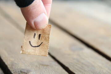 Smiley face on wooden background, copy space.