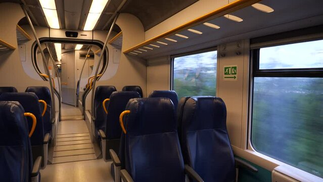 inside the moving passenger train as he passes through the woods and small Italian town