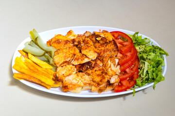 Turkish and Arabic Traditional Ramadan doner kebab with tasty tomato sauce and rice or turkish pilav in white plate on wood table background. ( Pilav ustu doner)