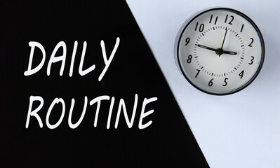 DAILY ROUTINE - words on black background and alarm clock on white
