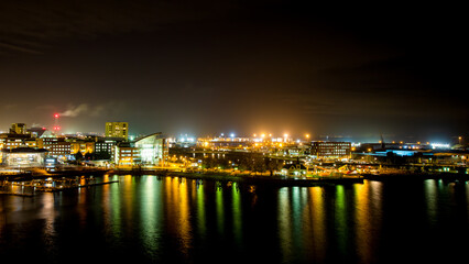 Fototapeta na wymiar city skyline at night reflected in bay
