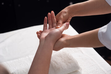 Masseur doing hand massage with oil in spa salon. Spa procedures. Body care concept. Close-up view