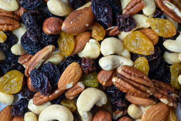set of nuts and oriental sweets and raisins as a background