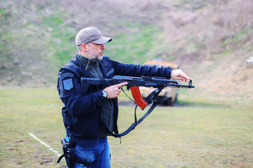 Instructor man, gun and learning to shoot outdoor at shooting range for target training. Safety and security with hand teaching person sport game 